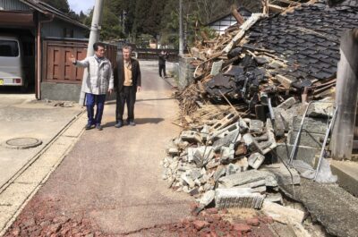 被災者（右側）の案内で、全壊家屋が多くある地域を調査する田村議員＝１８日、石川県珠洲市