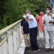 越水した重留川を調査する（右から）まつざき候補、田村議員ら＝12日、鹿児島県伊佐市